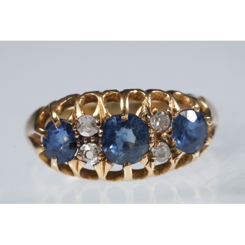 17 - 18ct gold, sapphire and diamond ring being set with three round cut blue sapphires with four diamond... 