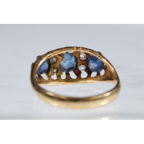 17 - 18ct gold, sapphire and diamond ring being set with three round cut blue sapphires with four diamond... 