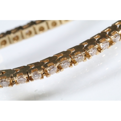 20 - 14ct gold and diamond line bracelet. The bracelet set with approx 61 round brilliant cut diamonds es... 