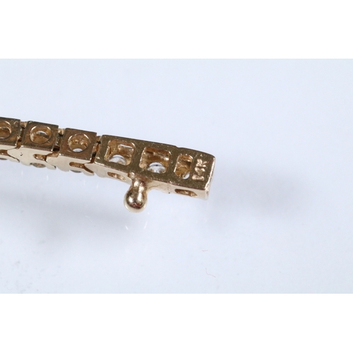 20 - 14ct gold and diamond line bracelet. The bracelet set with approx 61 round brilliant cut diamonds es... 