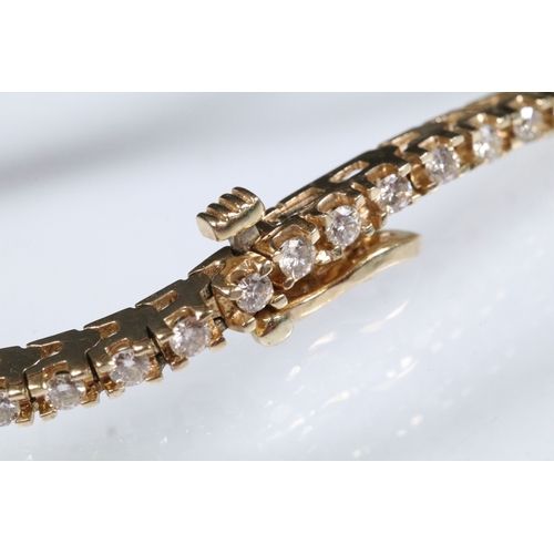 20 - 14ct gold and diamond line bracelet. The bracelet set with approx 61 round brilliant cut diamonds es... 
