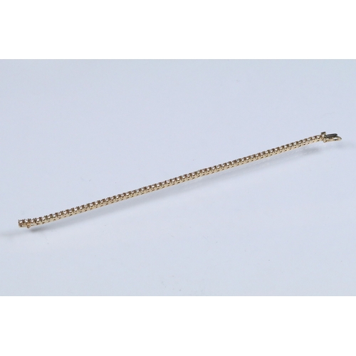20 - 14ct gold and diamond line bracelet. The bracelet set with approx 61 round brilliant cut diamonds es... 