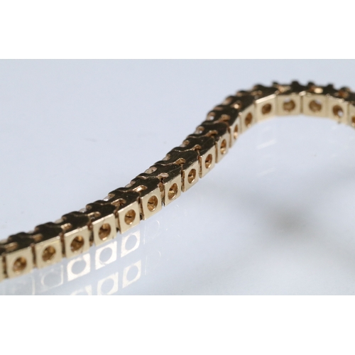 20 - 14ct gold and diamond line bracelet. The bracelet set with approx 61 round brilliant cut diamonds es... 