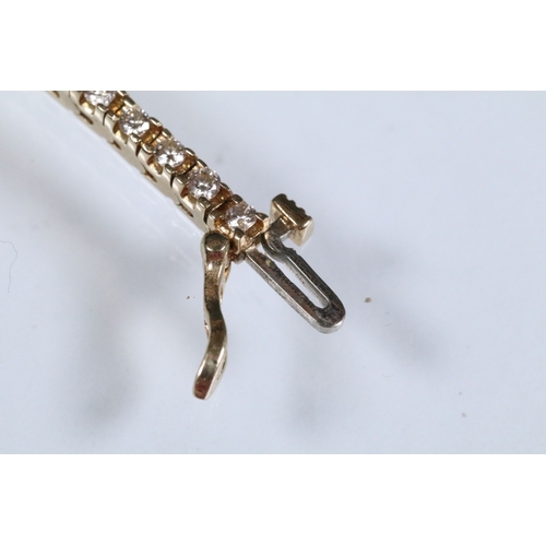 20 - 14ct gold and diamond line bracelet. The bracelet set with approx 61 round brilliant cut diamonds es... 