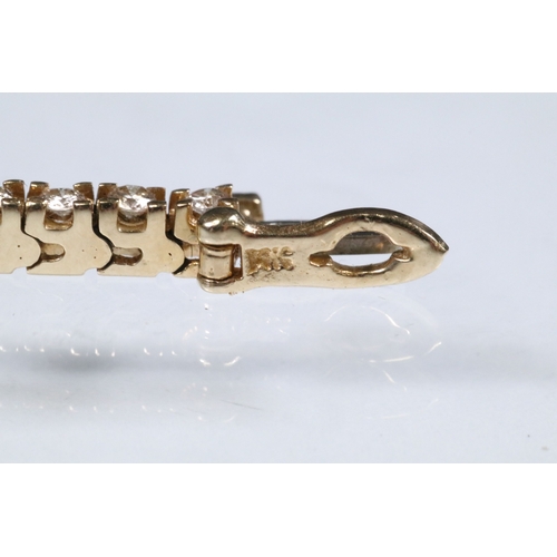 20 - 14ct gold and diamond line bracelet. The bracelet set with approx 61 round brilliant cut diamonds es... 