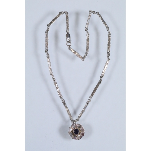 23 - Karina Gill silver and amethyst pendant necklace. The necklace constructed from textured bar links w... 