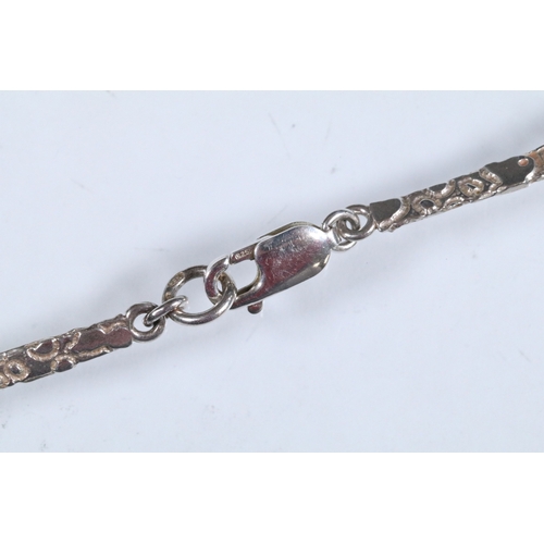 23 - Karina Gill silver and amethyst pendant necklace. The necklace constructed from textured bar links w... 