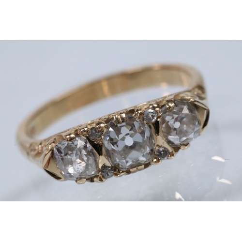 12 - Early 20th Century 18ct gold and diamond three stone ring. The ring being set with three old cushion... 
