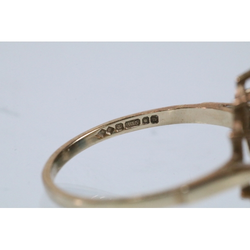 46 - 9ct gold and opal cluster ring. The ring being set with an oval opal cabochon to centre with a halo ... 