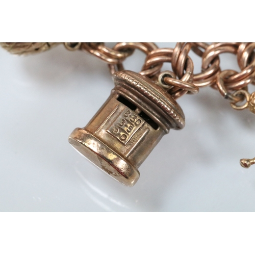 49 - 9ct gold charm bracelet having a double curb link chain. All charms hallmarked apart from carriage, ... 