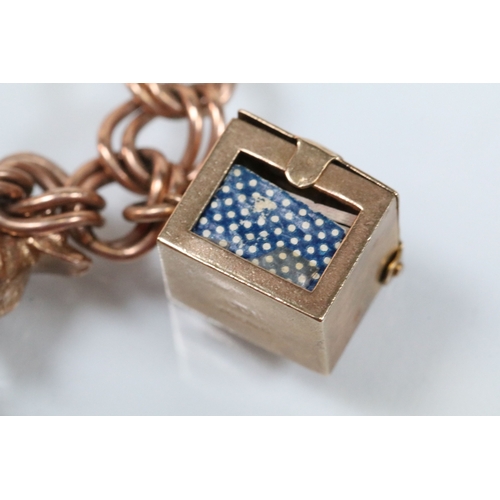 49 - 9ct gold charm bracelet having a double curb link chain. All charms hallmarked apart from carriage, ... 