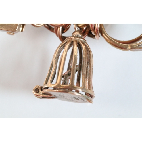 49 - 9ct gold charm bracelet having a double curb link chain. All charms hallmarked apart from carriage, ... 
