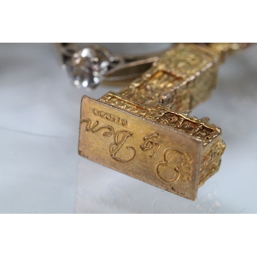 49 - 9ct gold charm bracelet having a double curb link chain. All charms hallmarked apart from carriage, ... 