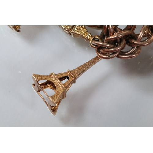 49 - 9ct gold charm bracelet having a double curb link chain. All charms hallmarked apart from carriage, ... 