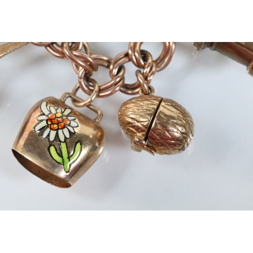 49 - 9ct gold charm bracelet having a double curb link chain. All charms hallmarked apart from carriage, ... 