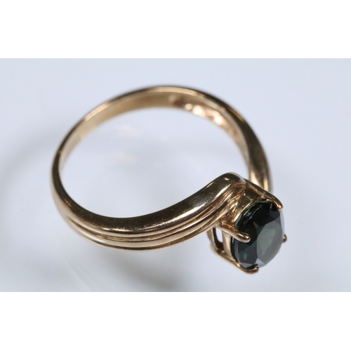 148 - 9ct gold and green tourmaline cross over ring set with an oval cut tourmaline to the centre. Hallmar... 