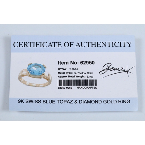 159 - 9ct gold and topaz dress ring set with an oval cut topaz flanked by two diamond accent stones. Hallm... 