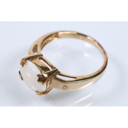 167 - 9ct gold and opal ring set with an oval opal cabochon with two diamond accent stones. Hallmarked Bir... 