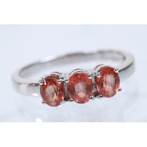 175 - 18ct white gold and Padparadscha sapphire three stone ring, prong set with three oval cut sapphires.... 