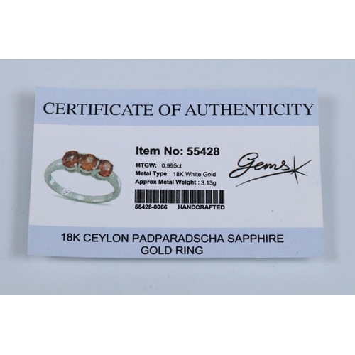 175 - 18ct white gold and Padparadscha sapphire three stone ring, prong set with three oval cut sapphires.... 