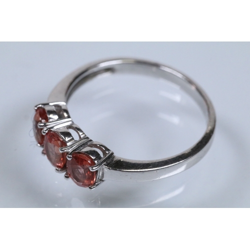 175 - 18ct white gold and Padparadscha sapphire three stone ring, prong set with three oval cut sapphires.... 