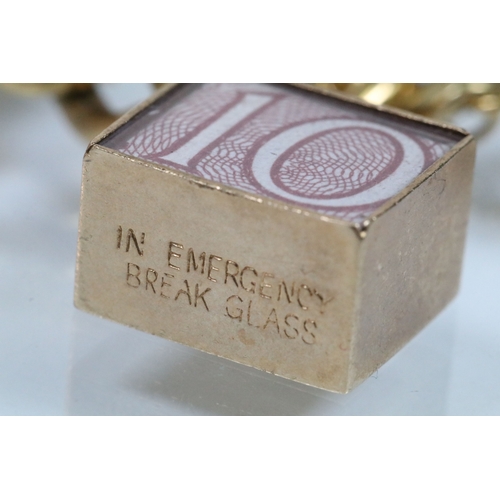 177 - Vintage rolled gold charm bracelet with a curb link chain having four 9ct gold bank note charms (all... 