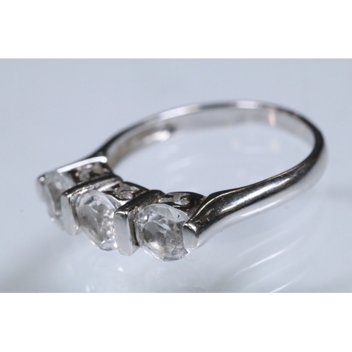 179 - 9ct white gold and white topaz three stone ring. Hallmarked Birmingham 2006. Size N.