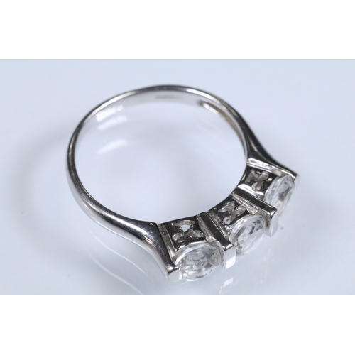 179 - 9ct white gold and white topaz three stone ring. Hallmarked Birmingham 2006. Size N.