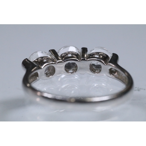 179 - 9ct white gold and white topaz three stone ring. Hallmarked Birmingham 2006. Size N.