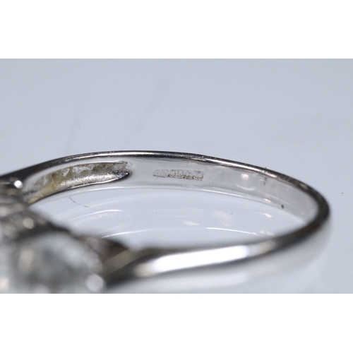 179 - 9ct white gold and white topaz three stone ring. Hallmarked Birmingham 2006. Size N.