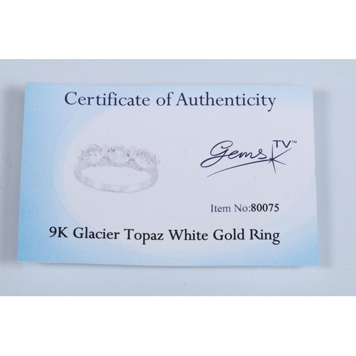 179 - 9ct white gold and white topaz three stone ring. Hallmarked Birmingham 2006. Size N.