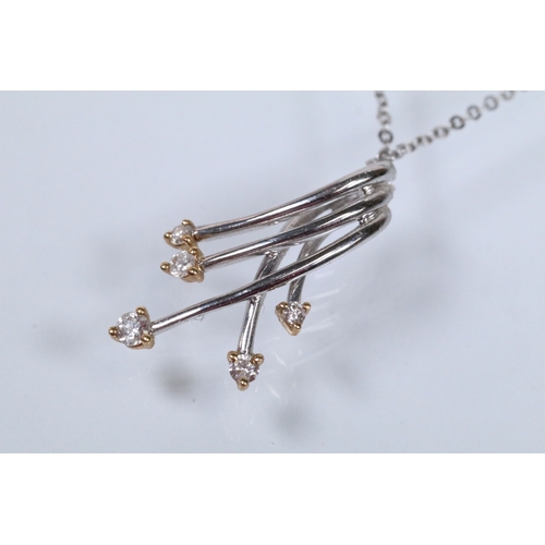 127 - 18ct white gold and diamond pendant necklace. The pendant of crossover form set with five round bril... 