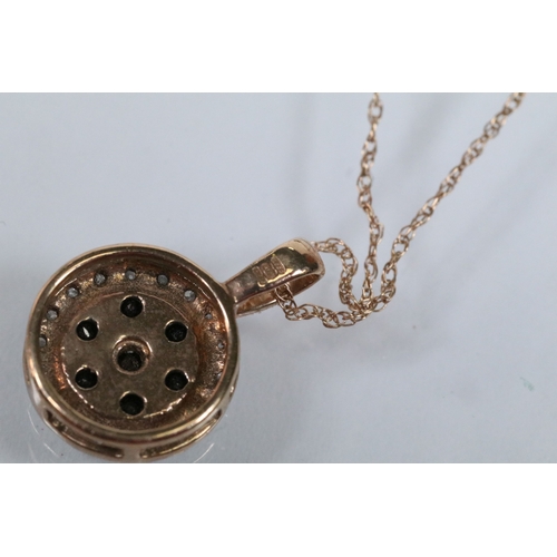 129 - Two 9ct gold pendant necklaces to include a black and white diamond pendant on a fine link chain (pe... 