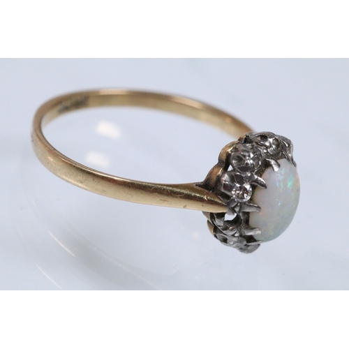 135 - 18ct opal and diamond halo ring having an opal cabochon to the centre with a halo of round cut diamo... 