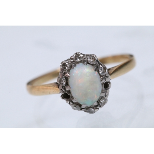 135 - 18ct opal and diamond halo ring having an opal cabochon to the centre with a halo of round cut diamo... 