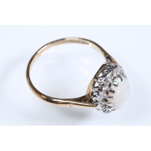 139 - 9ct gold, opal and diamond halo ring. The ring being set with an oval opal cabochon to the centre wi... 