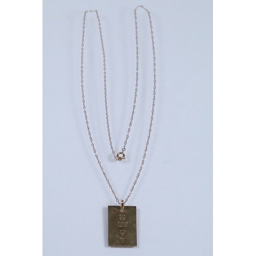 142 - 9ct gold ingot pendant (hallmarked London 1976) on a fine link chain (marked 9ct to the spring ring)... 