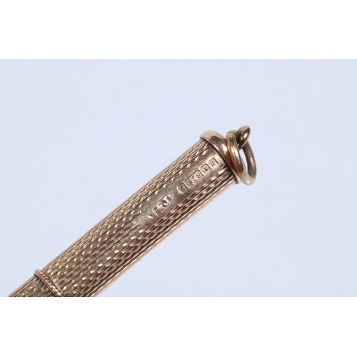 146 - 9ct gold engine turned mechanical tooth pick. Hallmarked Birmingham 1966. Measures 8cm when extended... 