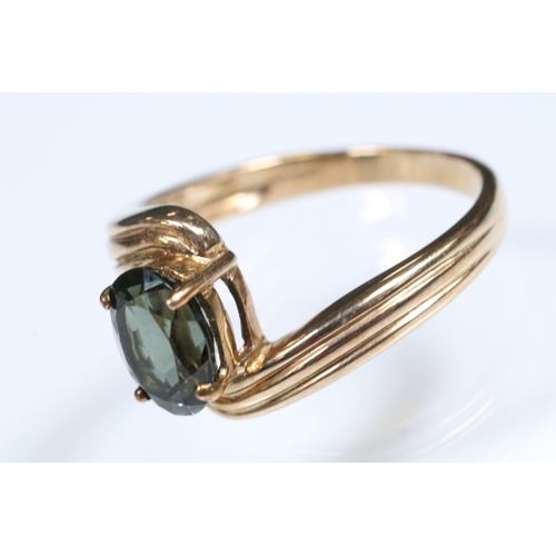 148 - 9ct gold and green tourmaline cross over ring set with an oval cut tourmaline to the centre. Hallmar... 