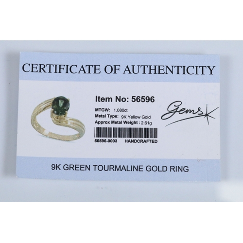 148 - 9ct gold and green tourmaline cross over ring set with an oval cut tourmaline to the centre. Hallmar... 