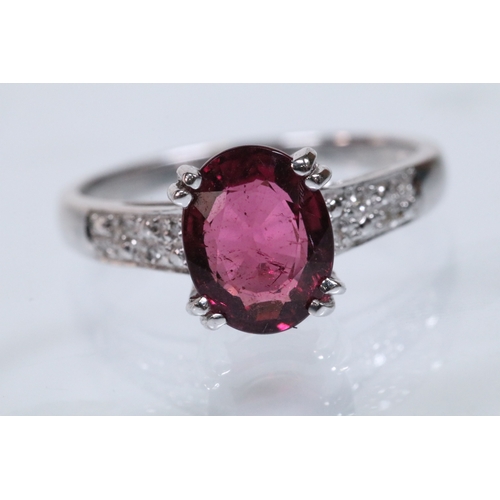154 - 18ct white gold and rubellite (red tourmaline) and diamond dress ring. The ring being set with an ov... 
