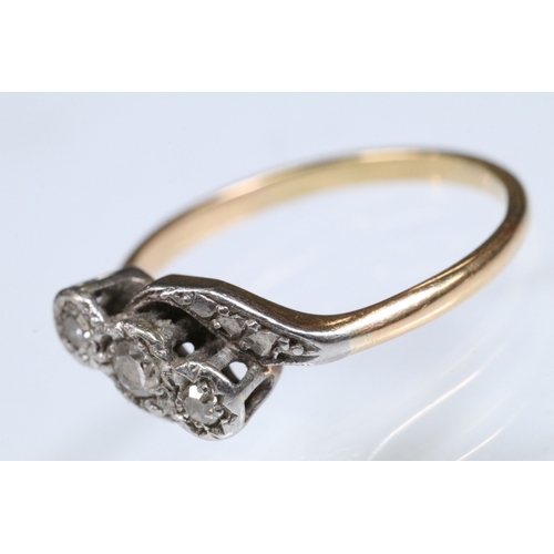 161 - Early 20th Century three stone diamond ring with a cross over setting. Unmarked, tests indicate 18ct... 