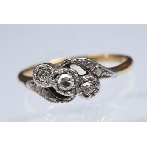 161 - Early 20th Century three stone diamond ring with a cross over setting. Unmarked, tests indicate 18ct... 