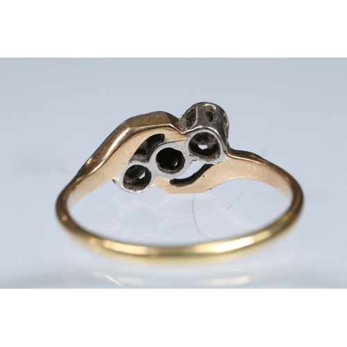 161 - Early 20th Century three stone diamond ring with a cross over setting. Unmarked, tests indicate 18ct... 