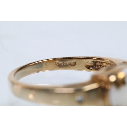 167 - 9ct gold and opal ring set with an oval opal cabochon with two diamond accent stones. Hallmarked Bir... 