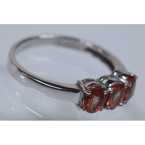 175 - 18ct white gold and Padparadscha sapphire three stone ring, prong set with three oval cut sapphires.... 