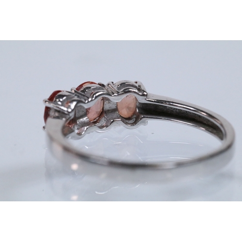175 - 18ct white gold and Padparadscha sapphire three stone ring, prong set with three oval cut sapphires.... 