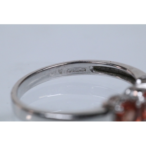 175 - 18ct white gold and Padparadscha sapphire three stone ring, prong set with three oval cut sapphires.... 