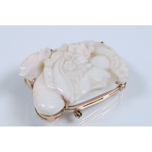 26 - 20th Century carved opal cameo brooch featuring a left facing female portrait set within a 9ct gold ... 