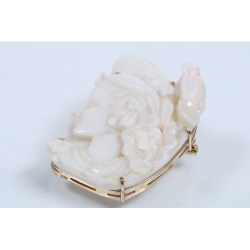 26 - 20th Century carved opal cameo brooch featuring a left facing female portrait set within a 9ct gold ... 